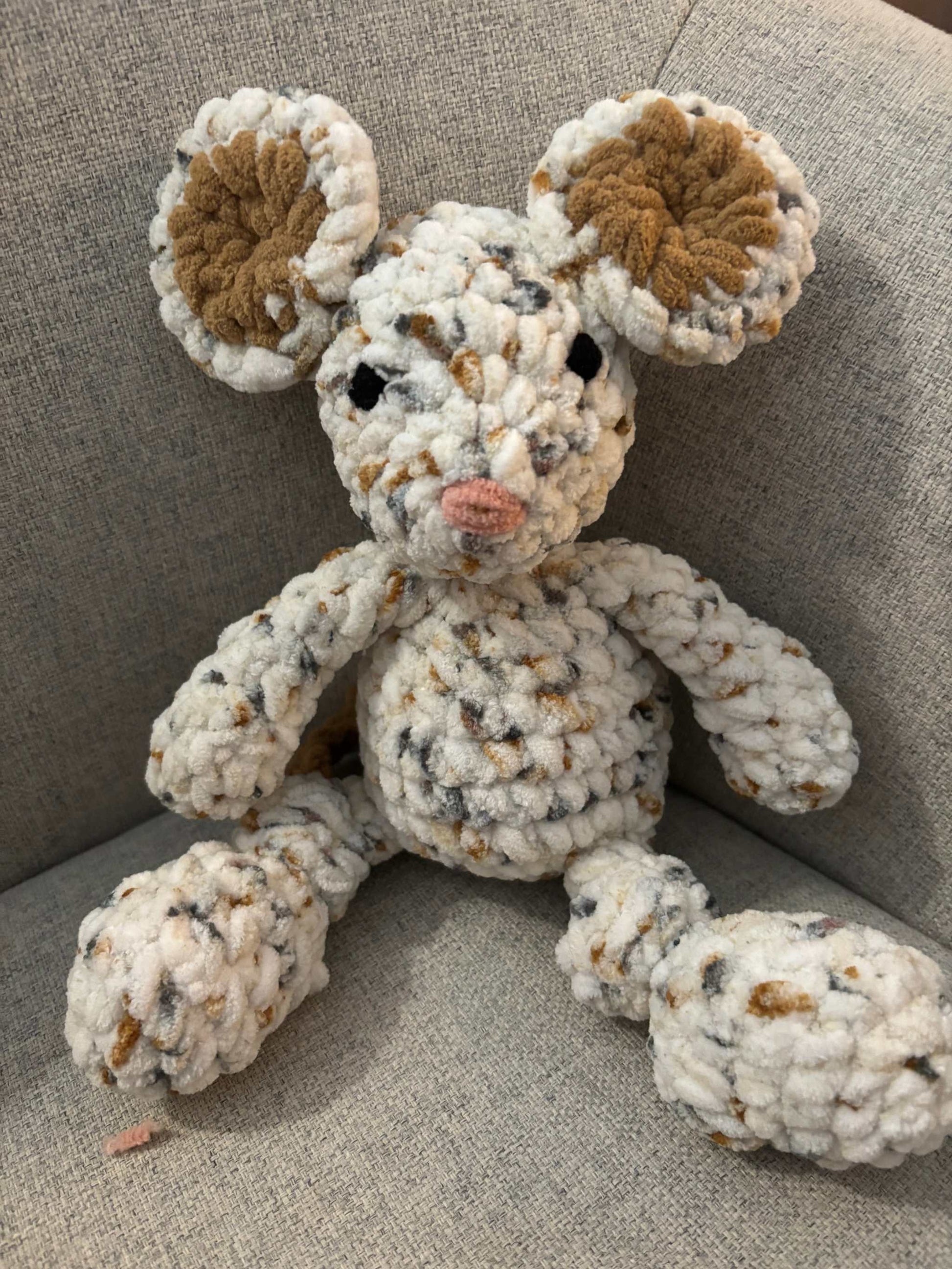 cute toy mouse sitting in a chair