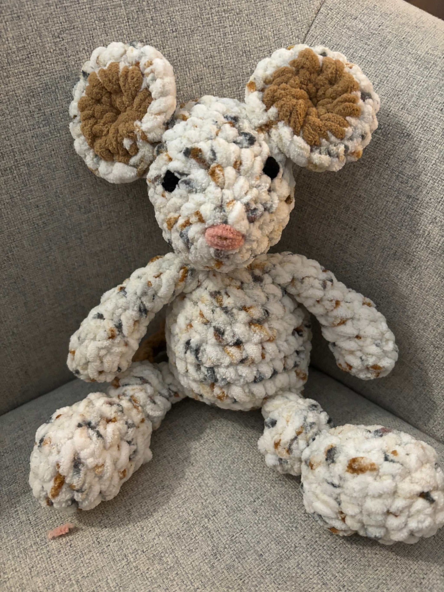 Cute toy mouse sitting front facing