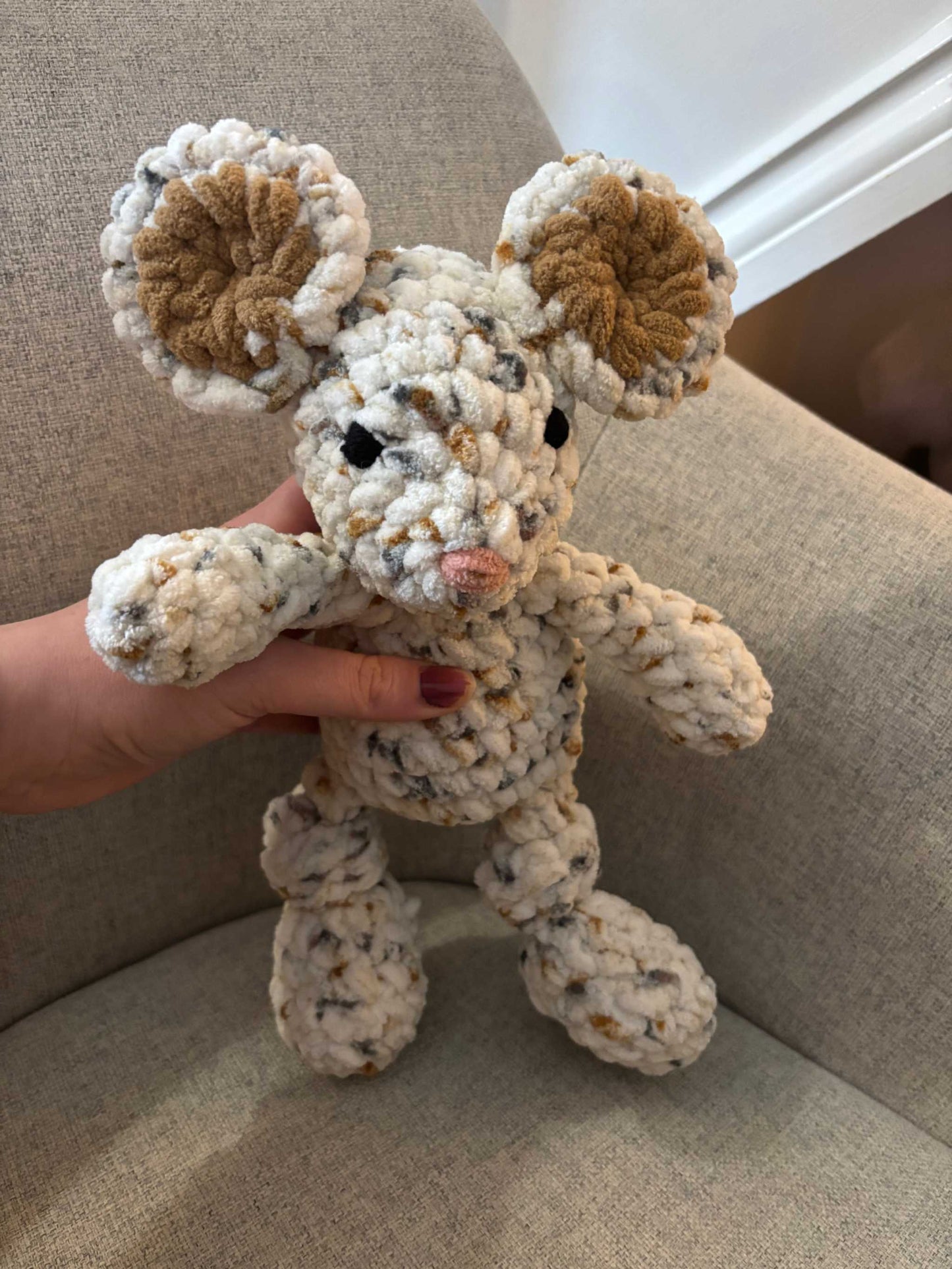 Cute toy mouse being held up
